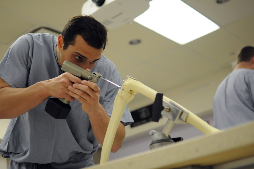 Francis Lovecchio, ’16 MD, uses an oscillating saw while practicing a total knee implant on synthetic bone models. "The session taught me the basics of handling various orthopaedic power instruments, which I know will help me look more comfortable in the operating room. Having an early exposure to a step-by-step tutorial will ensure I get the most out of my beginning years in residency." 