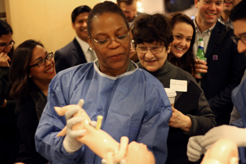 An attendee practices a delivery simulation where both the baby and mother are high-tech mannequins. Scenarios such as these are used to train Feinberg medical students, residents and Northwestern Medicine physicians.
