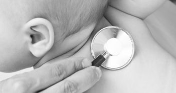 Children's doctor exams infant with stethoscope