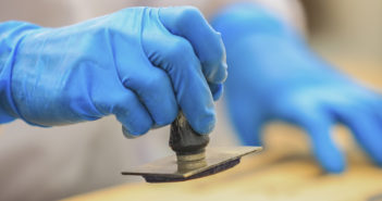 workers knot rubber stamp on the box.