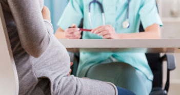 Thyroid Treatment in Pregnancy Does Not Improve Children’s IQ Close-up of a pregnant woman during medical visit