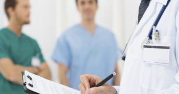 Evaluating Active Surveillance in Prostate Cancer Closeup Of A Doctor Writing Reports On A Paper