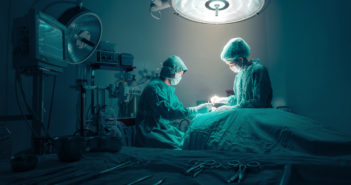 Surgical Residents Adapting to Flexible Shift Hours Surgeons team working with Monitoring of patient in surgical operating room.