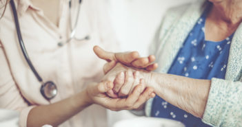 Bringing Geriatric Care Home Social worker is visiting a senior woman in her own apartment.