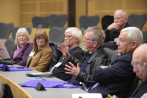 Craig Showalter, ’68 MD, asks a question during an Alumni Weekend forum (middle), with Steve Embry, ’68 MD, right.