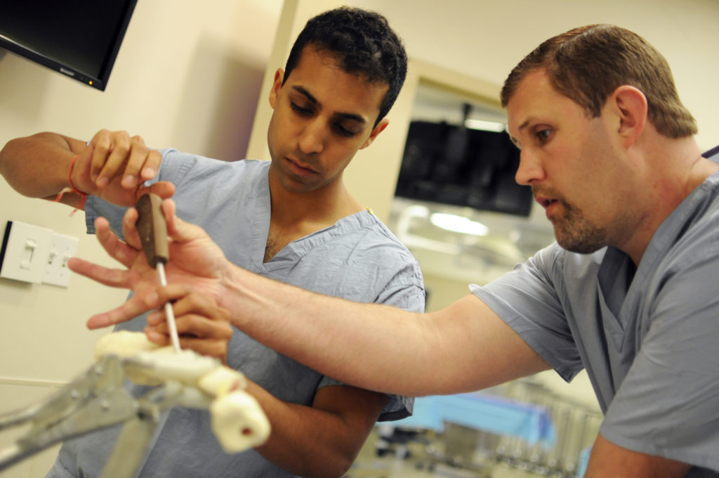 Beal reminds students that the goal of the session is to become comfortable with the tools they will be using as future orthopaedic surgeons. “If you’ve seen it once before, you aren’t thinking about how to hold a saw or drill, and you’ll be more focused on how to do the procedure,” he said.  