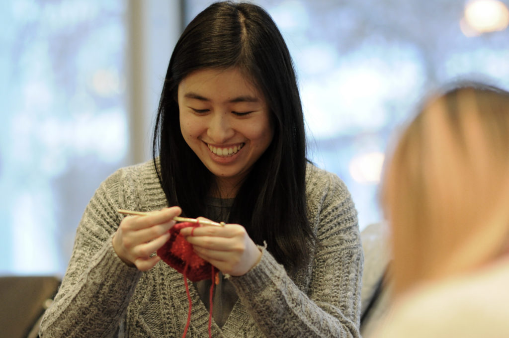 Medical students crochet baby hats to those in need at Apna Ghar, an organization that helps immigrant communities work to end gender violence.