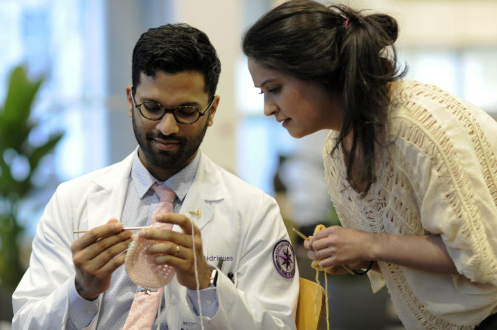 Lauren Andrews (right), a third-year medical student, started the group, Fein Yarns and Healing Threads, as a way to help rehabilitation patients with their fine motor skills and to provide baby hats to immigrant communities.