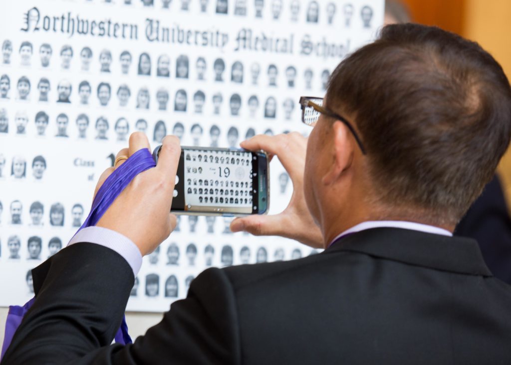 Alumni viewed class photos hung in Method Atrium throughout the weekend.