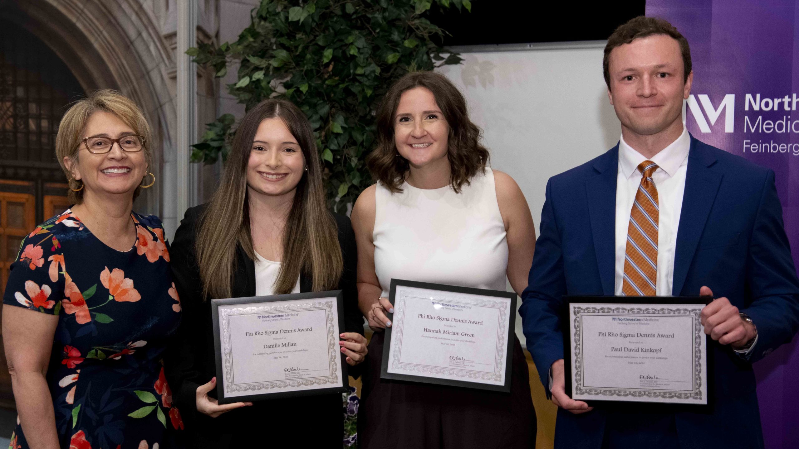 Sandra Sanguino, ‘93 MD, MPH, senior associate dean for Medical Education, presents the Phi Rho Sigma Dennis Award for outstanding performance in junior year clerkships to fourth-year medical students Danielle Millan, Hannah Miriam Green and Paul Kinkopf. Photo: Nathan Mandell