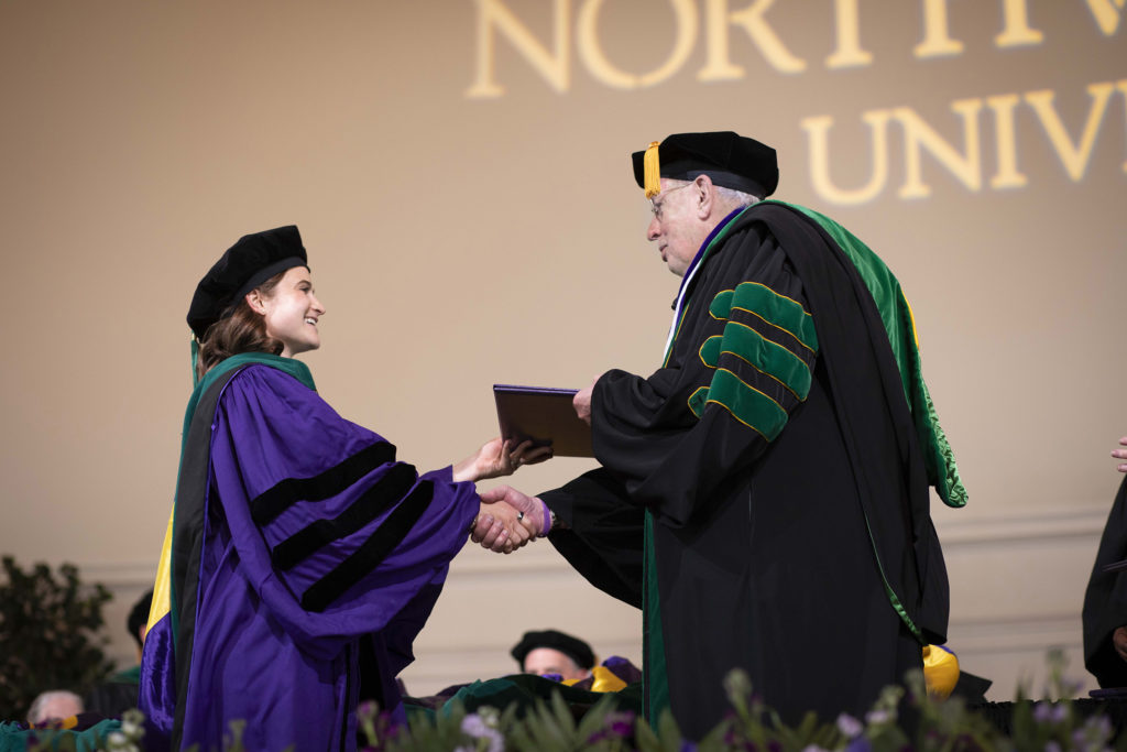Eric G. Neilson, MD, vice president for Medical Affairs and Lewis Landsberg Dean, presenting medical students with their diplomas.