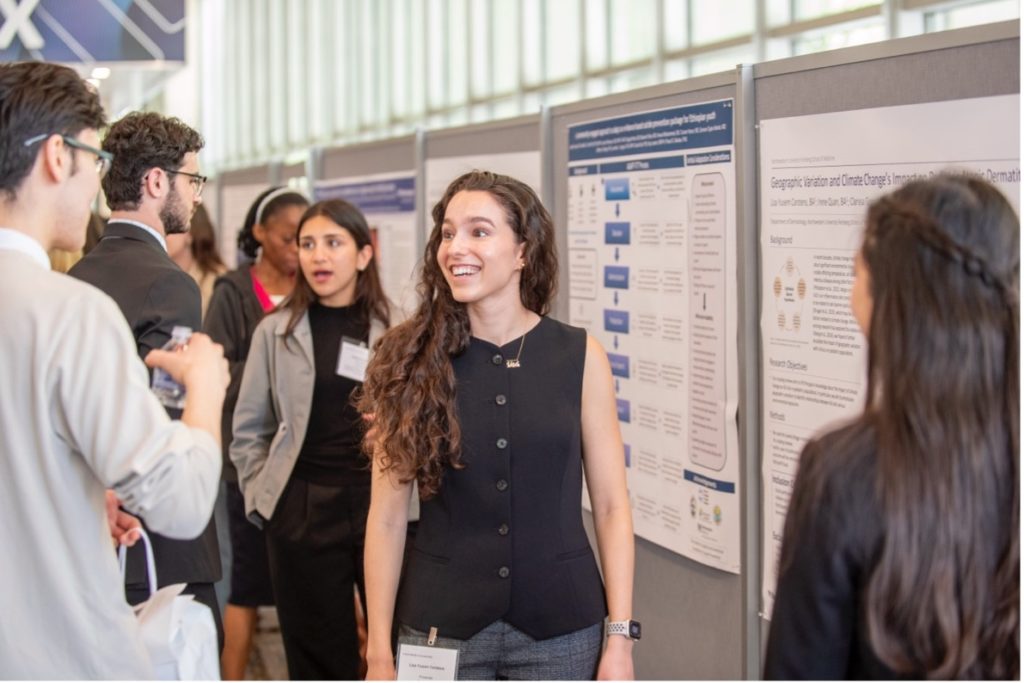 Students, faculty and staff at a poster session during Global Health Education Day
