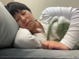 Yayun Du, PhD, models the wearable sleep monitoring device that is placed on her neck.