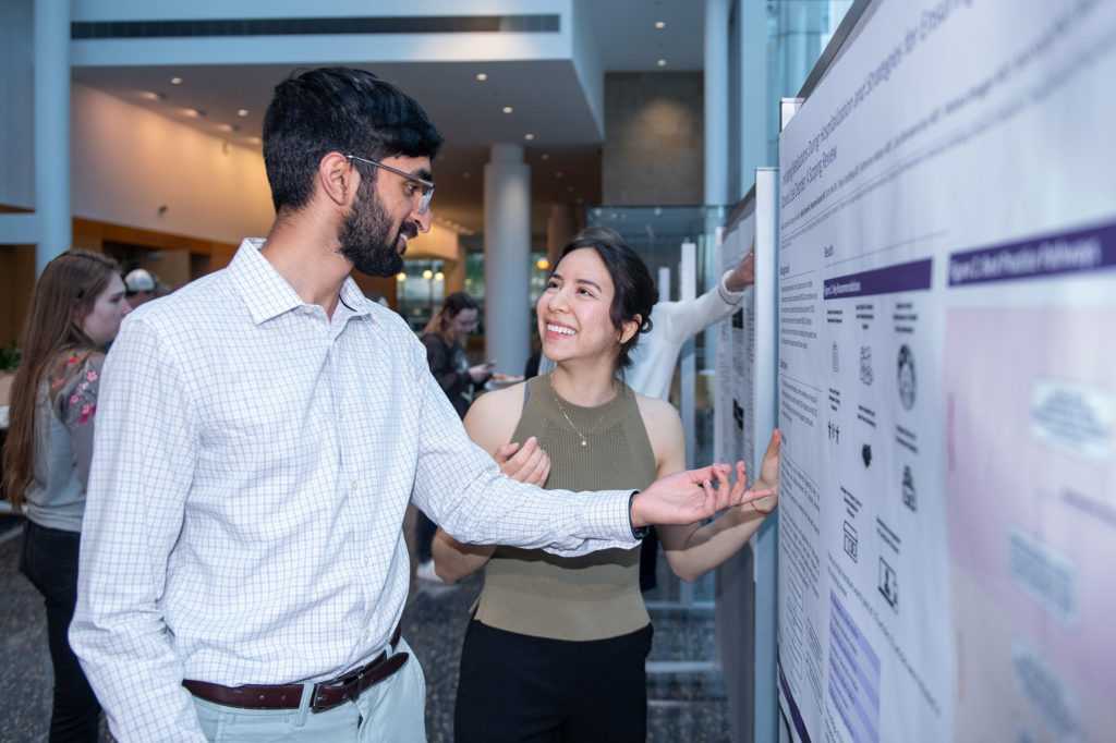 Nikhil Sriram and Marianne Kanaris discuss their research findings during the Second Opinions Poster Showcase. 
