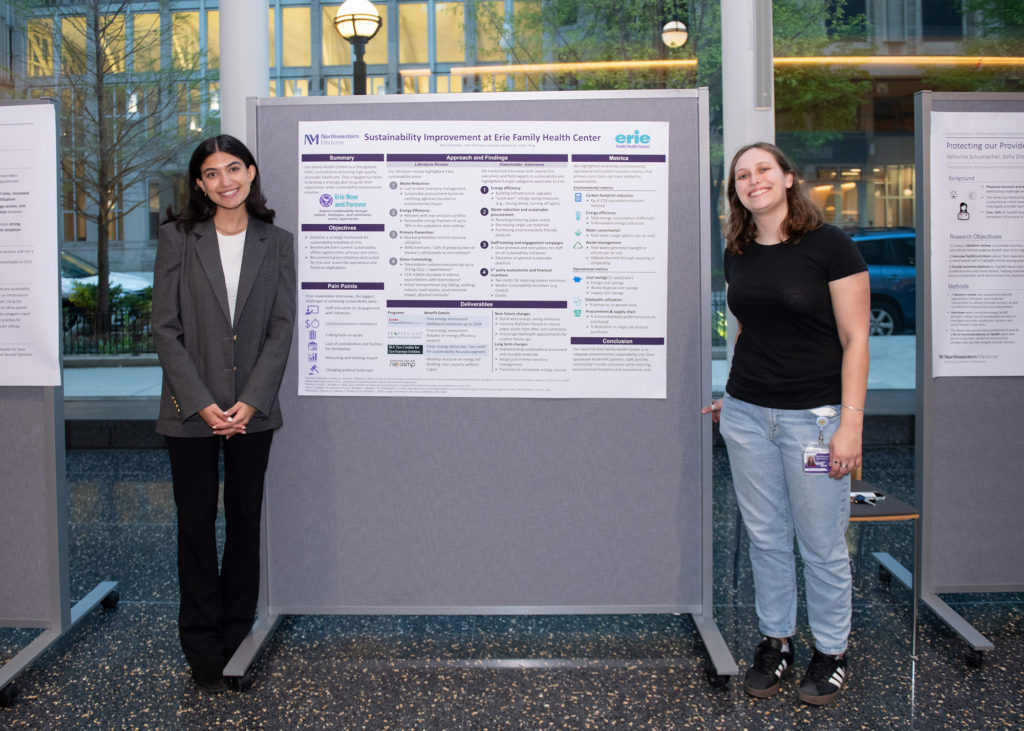 Julie Elfishawy and Aden Goolsbee pose next to their research presentation,  “Sustainability Improvement and Erie Family Health Centers.”