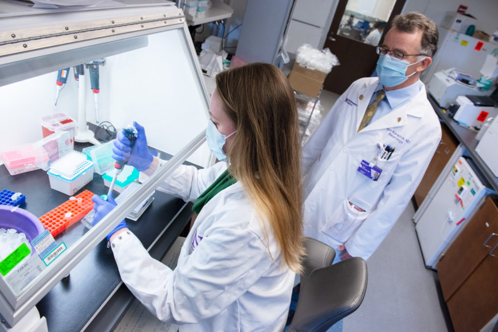 Postdoctoral fellow Barbara Hanson, PhD, and Igor Koralnik, MD, chief of Neuroinfectious Diseases and Global Neurology in the Department of Neurology, in the laboratory.