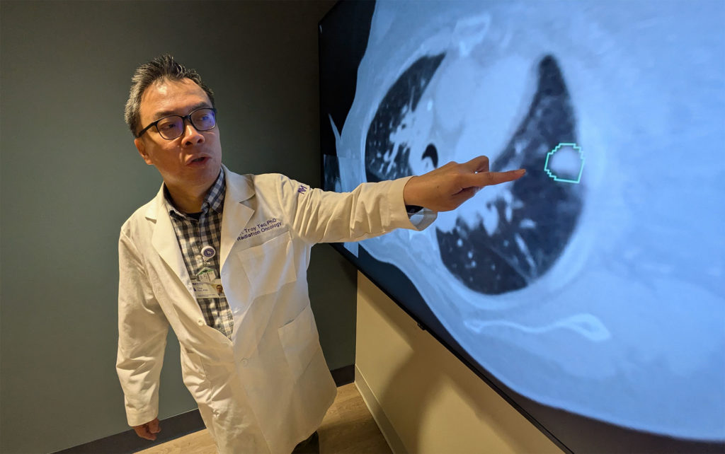 Study co-author Troy Teo, PhD, an instructor in the Department of Radiation Oncology,  shows how a new AI tool contours a lung tumor as it moves with each breath.