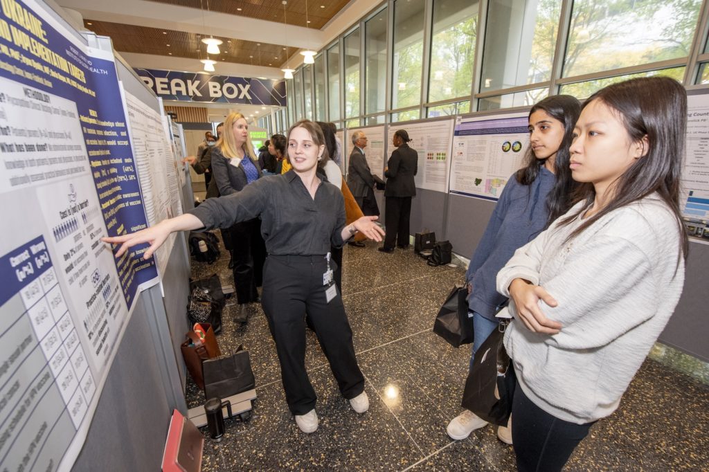 Mariia Shipovskaia, MD, a research assistant in the Department of Surgery, presents her research poster about HPV vaccination knowledge and practice in Ukraine during the Global Health Day poster session.