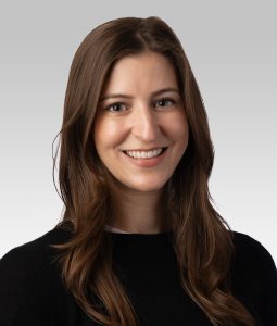 Livia Guadagnoli, ‘20 PhD, posing for a headshot wearing a black turtleneck. 